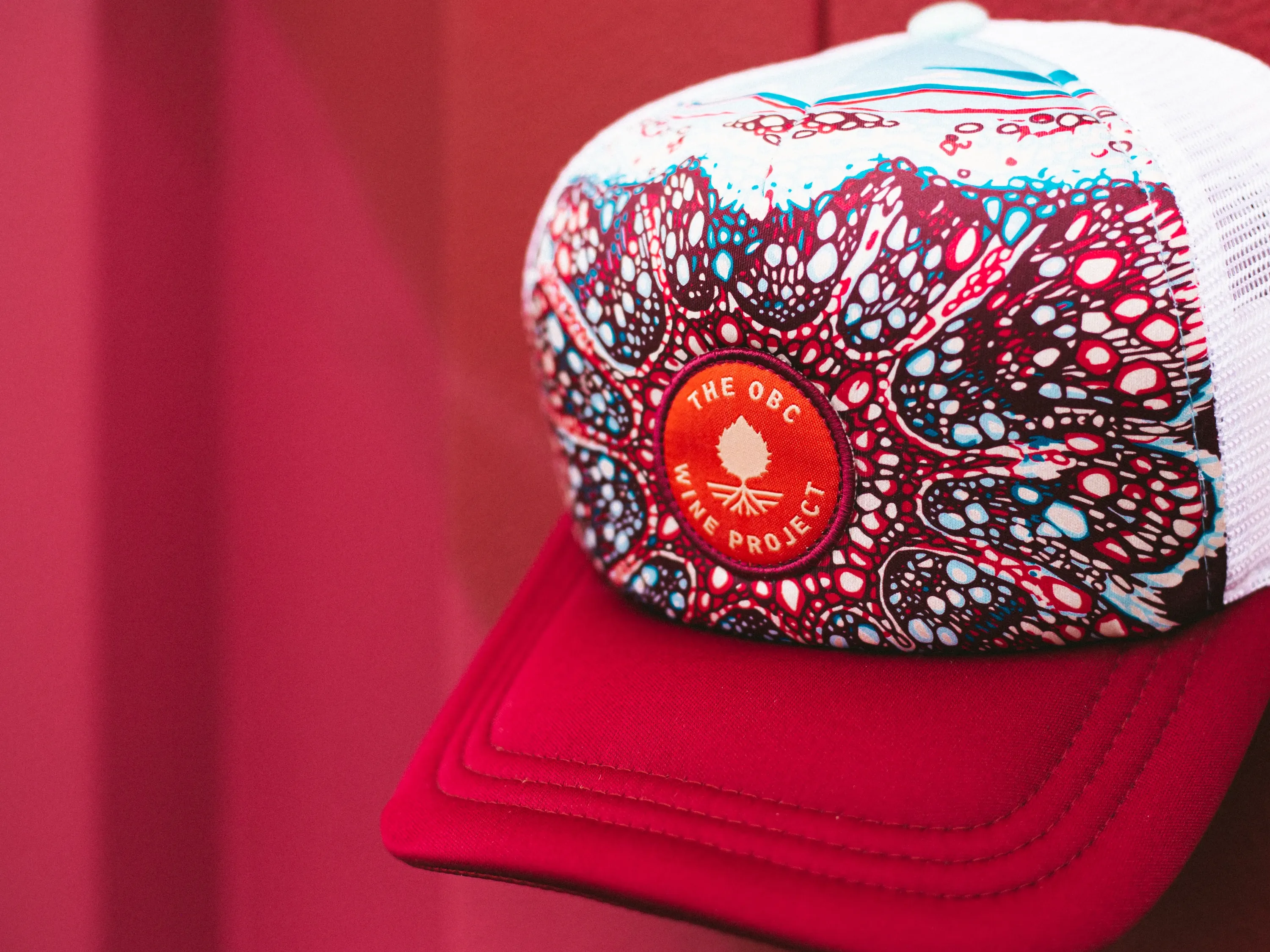 The obc wine project sublimated trucker hat by anthem branding